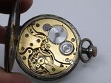 a close up of a pocket watch being held by a person