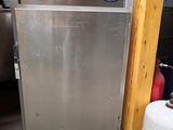 an image of a stainless steel refrigerator in a garage