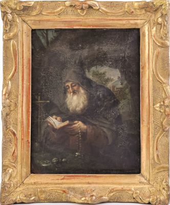 un tableau représentant un vieil homme en train de lire un livre, dans un cadre doré