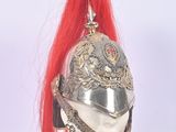 a silver helmet with red hair on top of a mannequin head