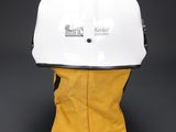 a white hard hat with yellow gloves on a black background