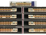 several model trains are stacked in a display case on a white surface