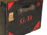 a black suitcase with a red and black label on it