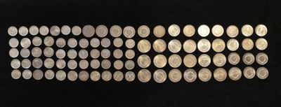a close up of a row of coins on a black surface