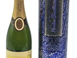 La bouteille de champagne se trouve à côté de la boîte de vin.