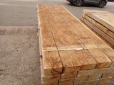 a pile of wood sitting on the side of the road