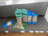 many bags of food sitting on a shelf in a store