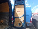 a blue van that is parked in a parking lot