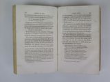 an open book on a table with a white background