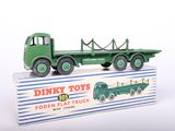 a green toy truck with a box on the back