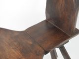 a wooden chair that has a wooden seat on it