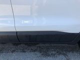 a close up of the side of a white car