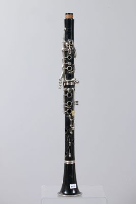 a close up of a black and silver clarinet on a clear stand