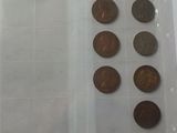 a lot of coins that are in a plastic container