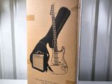 an electric guitar in a cardboard box sitting on a table