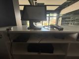 a desk with a computer monitor and a phone on it