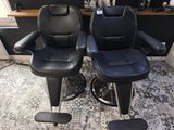 deux fauteuils inclinables en cuir noir, disposés comme dans un salon