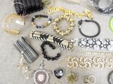 a lot of jewelry that is laying out on the table