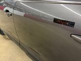 a close up of a car door with a sticker on it