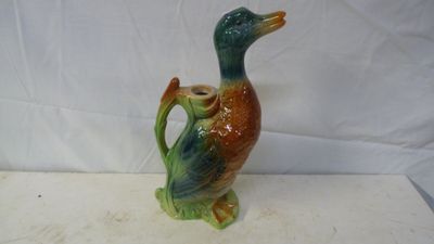 a ceramic duck that is sitting on top of a table