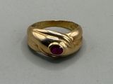 an image of a gold ring with a ruby stone