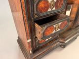 a wooden cabinet with two drawers on top of it
