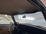a view of the inside of a car from the driver ' s seat