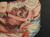 a hand holding a purse with a picture of a cow on it