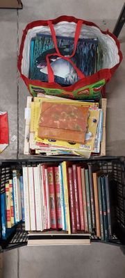 a basket full of books on the floor next to a chair