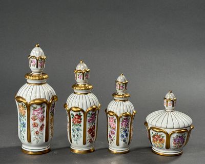 four pieces of porcelain vases with gold trim and flowers on them