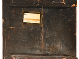 an old wooden box with a label on it sitting on top of a table