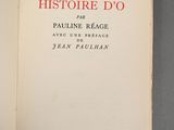 an open book on a table with a red and black cover