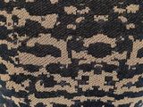 the back of a black and tan sweater with a pattern on it
