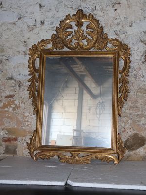 a mirror sitting on top of a table next to a brick wall