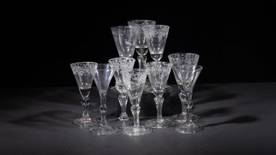 several empty wine glasses on a table with a black background