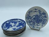 four blue and white plates are stacked on top of each other