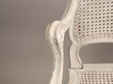 an image of a white wicker chair against a gray background