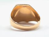 an image of a gold signet ring with a diamond in the center