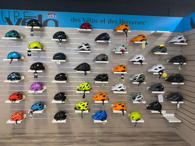 many helmets on display on the wall in the store