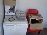 a small kitchen with a refrigerator, microwave, and a microwave oven