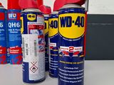 several cans of wd - 40 are lined up on a table