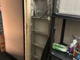 a room with a ladder and a book shelf in it