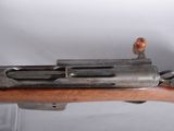 an old rifle with a wooden barrel and a wooden handle