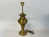an image of a brass lamp with a cord attached to it