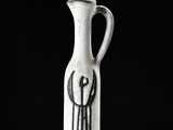 a white vase with a black design on it