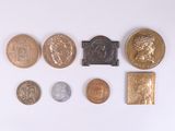 a lot of coins that are on a white surface