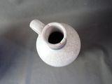 a small white vase with a cracky design on it