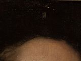 portrait of a man with a mustache and a beard in front of a black background