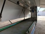 a conveyor belt in the back of a truck