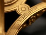 a close up of a gold clock with a clock face on it